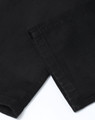 Black flexi chino pants with a smooth fabric texture, featuring a cuffed hem and subtle branding.