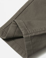 A close-up of the hem of khaki ladies' flexi chino pants, featuring a clean finish and tailored stitching.