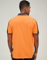 A safety polo shirt in bright orange with navy accents and a collar, viewed from the back. It features a logo.