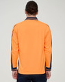 A long-sleeve polo in high-visibility orange with navy detailing and a logo on the back.