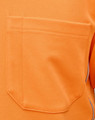 An orange safety polo shirt featuring a patch pocket and branded logo on the side.