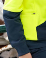 A bright yellow and dark navy fleece hoodie featuring a zippered pocket and ribbed cuffs. It has a logo on it.