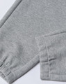 A pair of grey unisex sweatpants featuring an elasticated cuff and a logo on the waistband.