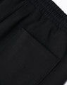 Black unisex sweatpants with an elastic waistband and a patch pocket on the side. Features a logo.