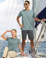 A pair of people wearing a light blue tee shirt on a sailboat, with a logo visible on the shirts.