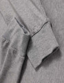 A grey long-sleeve tee shirt with a soft fabric and cuffed sleeves, featuring a logo on the side.
