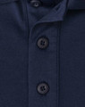 A navy blue polo shirt featuring a button placket and a logo. The fabric is a sustainable poly/cotton blend.