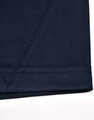 A close-up of a navy blue polo shirt featuring contrast stitching and a logo.