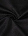 A close-up view of black sustainable poly/cotton fabric with a smooth texture and slight stretch.