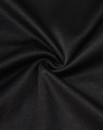 A close-up of black sustainable poly/cotton fabric, showing its smooth texture and stretch ability.