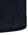 A close-up of a dark navy knit fabric with a hemmed edge, showcasing the texture and stitching details.