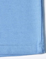 A blue traditional poly/cotton pique knit long sleeve polo shirt with a hem detail and a logo.