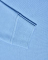A light blue long sleeve polo shirt made from poly/cotton pique knit, featuring ribbed cuffs.