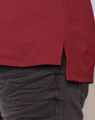 A red men's cotton polo shirt featuring a side split and a subtle logo detail.