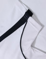 A white polo shirt with black trim and a textured fabric, featuring a logo.