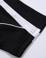 A close-up of a black polo shirt featuring white accents and a logo.