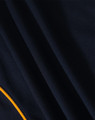 A navy polo shirt featuring a textured fabric and a contrasting yellow trim. It has a logo present.