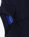 A navy blue men's cotton stretch polo shirt with a folded collar and a label visible inside.