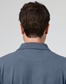 A men's cotton stretch polo shirt in a blue shade, featuring a collar and logo on the back.