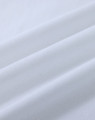 A close-up of white cotton fabric with soft, smooth texture, featuring natural wrinkles and folds.