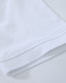 A close-up of a white cotton stretch polo shirt, showcasing the fabric and hem details. The shirt has a logo.