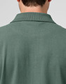 A men's cotton stretch polo shirt in a green hue, featuring a collared neckline and a back view.