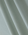 A close-up of light green cotton fabric, featuring a textured weave suitable for polo shirts.