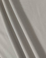 A textured, light grey fabric featuring soft folds. The material is suitable for polo shirts and has a subtle sheen.