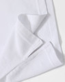 A close-up of a white polo shirt featuring a folded hem and a subtle logo.