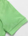 A green polo shirt featuring a pique texture, showcasing the collar and sleeve detail with a logo.