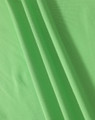 A close-up of soft, textured fabric in vibrant green, showcasing the material of a polo shirt.