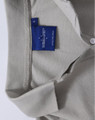 A grey Ladies' Truedry Pique Polo with a collar and buttons, featuring a logo tag inside the neckline.