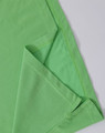 A green ladies' polo shirt featuring a folded sleeve and a hem detail, with a small logo present.