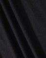 A close-up of black fabric showcasing the texture of a polo shirt. The material appears smooth and lightweight.