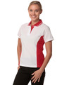 A white and red Ladies' TrueDry Contrast short-sleeve polo shirt displayed on a model, featuring a logo.
