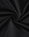 A close-up of black fabric with a smooth texture, showcasing the sustainable poly/cotton blend.