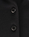 A close-up of a black polo shirt featuring buttons and a subtle texture, highlighting its sustainable fabric.