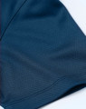A close-up of a navy blue jacquard knit fabric, featuring a smooth texture and intricate pattern.