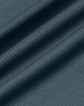 A textured fabric in a deep teal shade, featuring a jacquard knit pattern. It has a smooth finish and drapes softly.