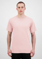 A plain pink short sleeve tee is displayed on a model against a neutral background. The shirt features a logo.