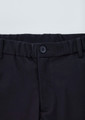 A close-up of black cargo pants featuring a button closure and elastic waistband. Logo present.