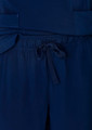 Navy blue women's straight leg scrub pants featuring a drawstring waist and pockets. Branding is present on the fabric.