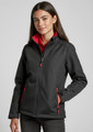 A fitted black jacket with red accents, featuring zippered pockets and a high collar, modelled by a young woman.