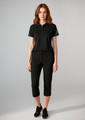 A women's black short sleeve polo shirt displayed with matching black pants, featuring a logo on the polo.