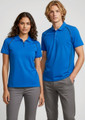 A blue short sleeve polo shirt for men, featuring a logo, styled with grey pants.