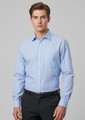 A light blue long sleeve button-up shirt with a pocket and a logo, worn by a model.