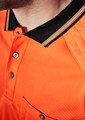 A close-up of an orange short sleeve polo shirt with a black collar and a logo. Features a pocket and buttons.