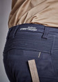 A close-up of navy shorts featuring a branded waistband and a ruler for measuring, highlighting the fabric's texture.