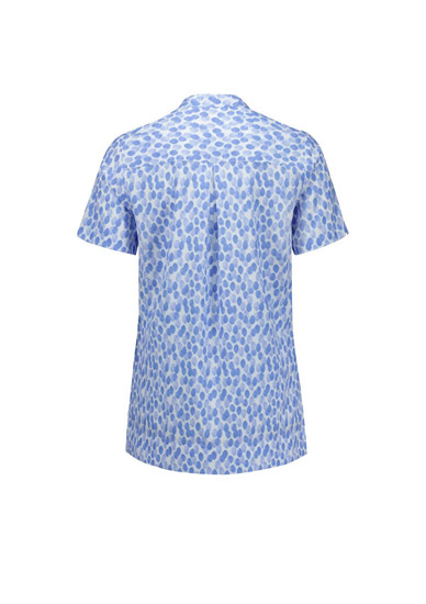 A short-sleeved tunic in a blue stardust print with a button-up collar and a logo on the back.