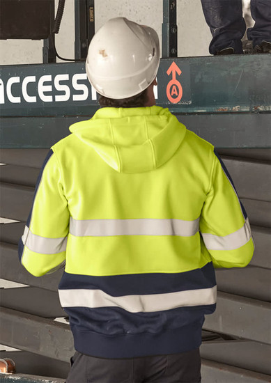 A unisex hi-vis full zip stretch taped hoodie in yellow and navy with reflective stripes, worn by a person in a hard hat.